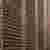 The image showcases a brick facade with a distinctive perforated pattern. The brickwork is arranged 