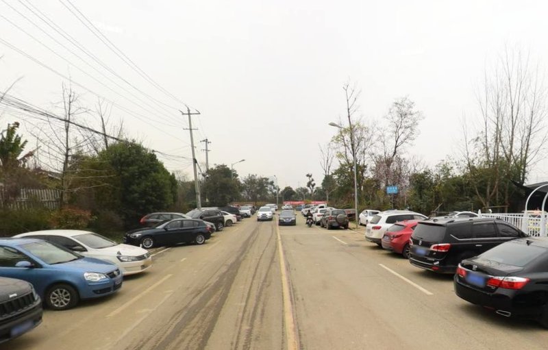 Passengers park their cars on both sides of the road