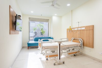 This architectural image showcases a modern hospital room designed for patient comfort and functiona