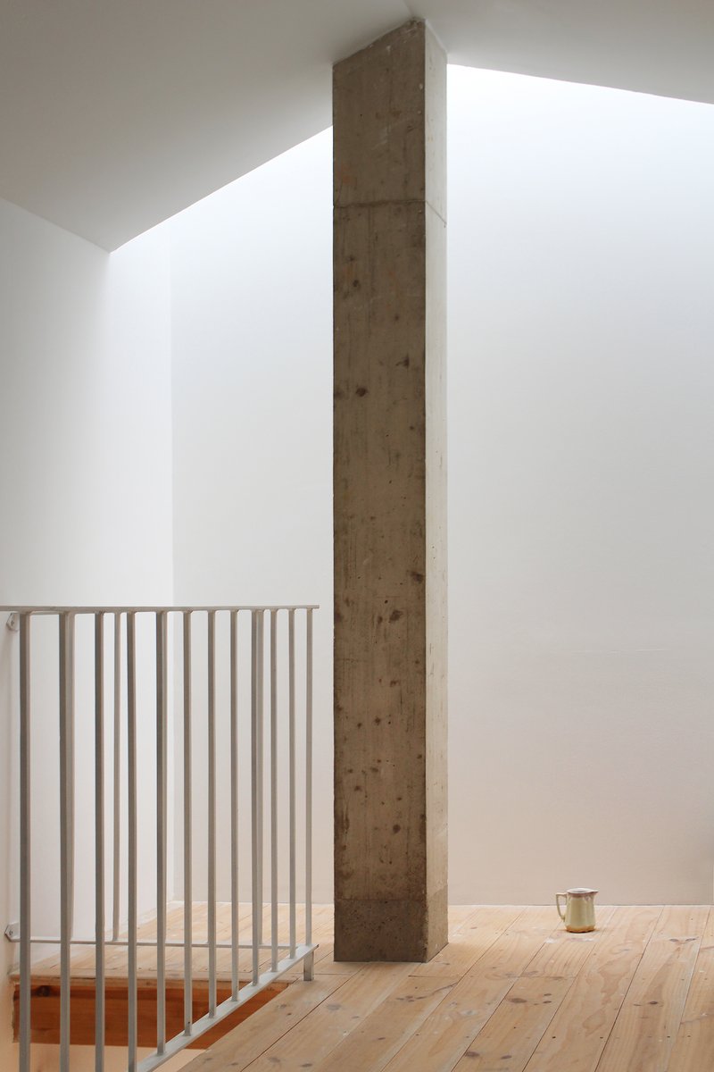 Quiet upper landing with a single timber column rising the full height of the room