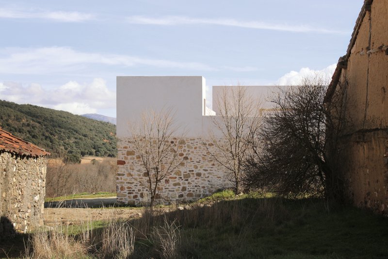 Winter view of the house from a neighbouring lane with mountains beyond