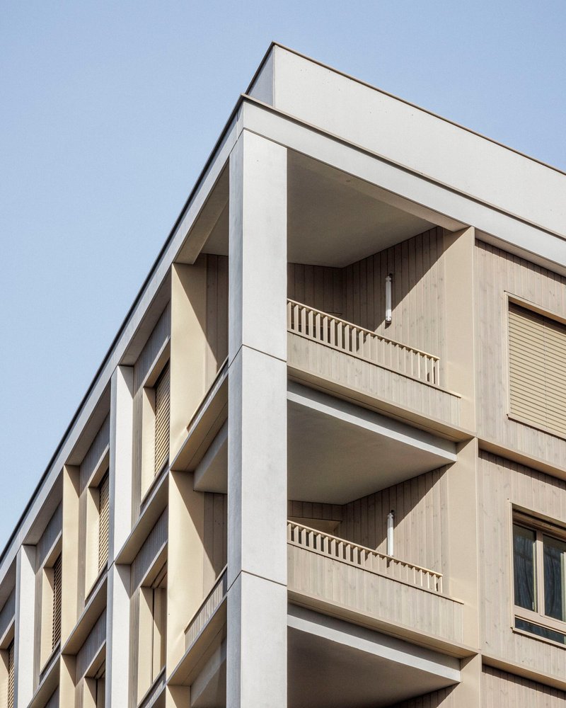 Detail of the student residence corner with deep concrete reveals and timber balcony screens