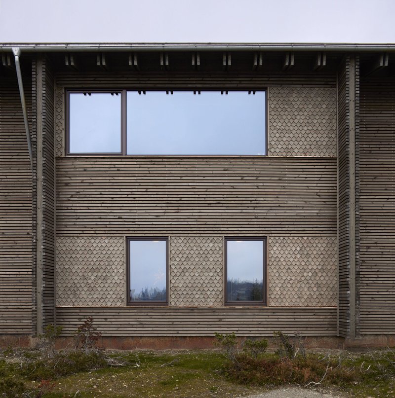 Front facade: large panoramic window above, paired bedroom windows below