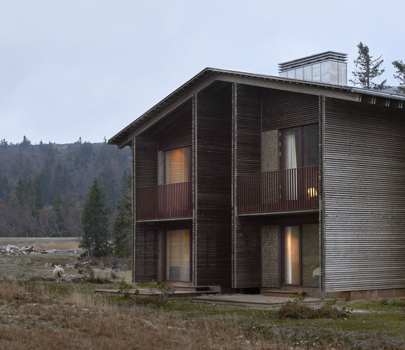 Full two-storey volume with balconies and ventilated timber facade